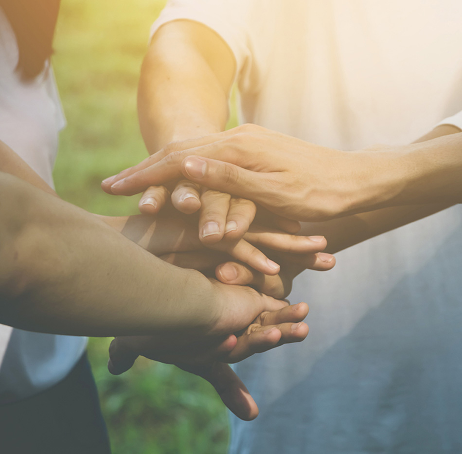 peoples hands on top of each other.