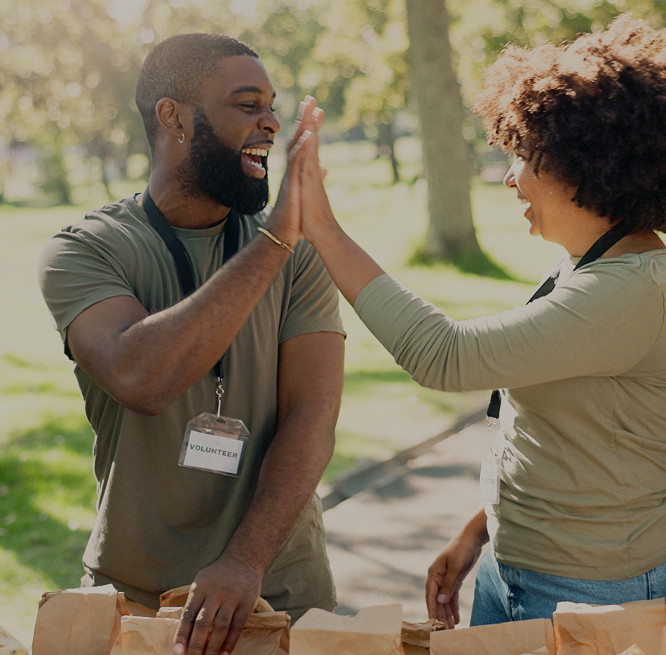 Black male high fiving black female at food drive event