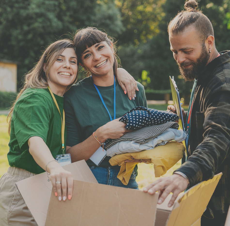 Three volunteers filling boxes outdoors