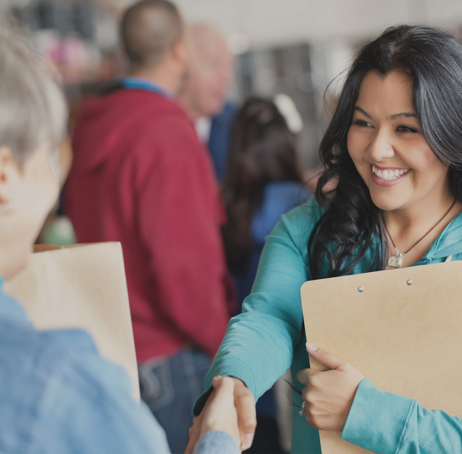 Women shaking hands at volunteer event