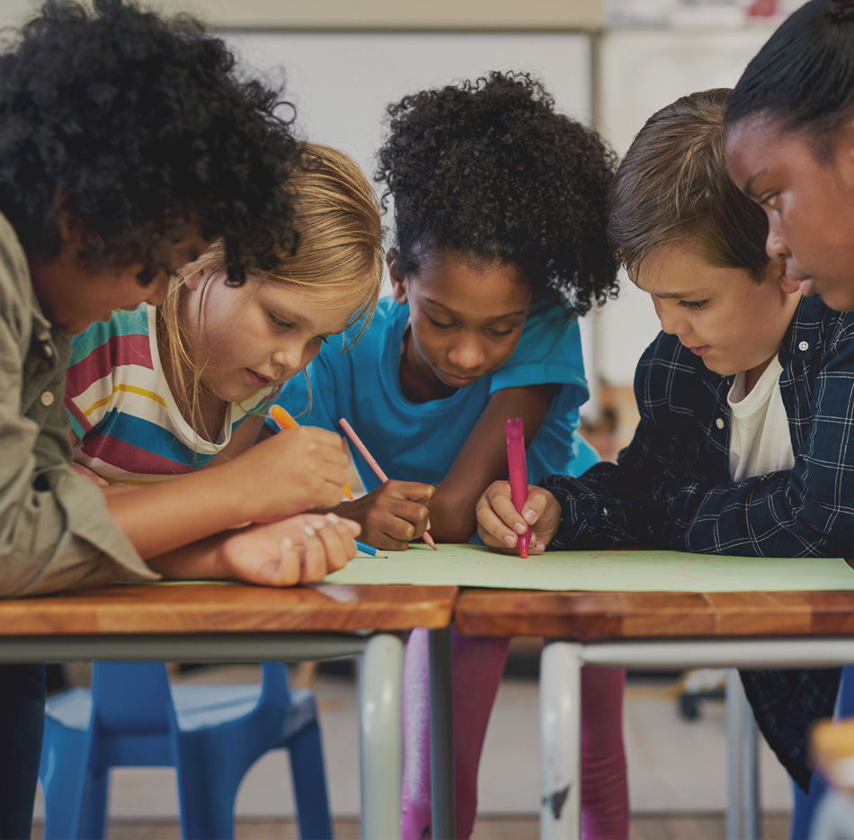 Diverse group of tweens working on a project together