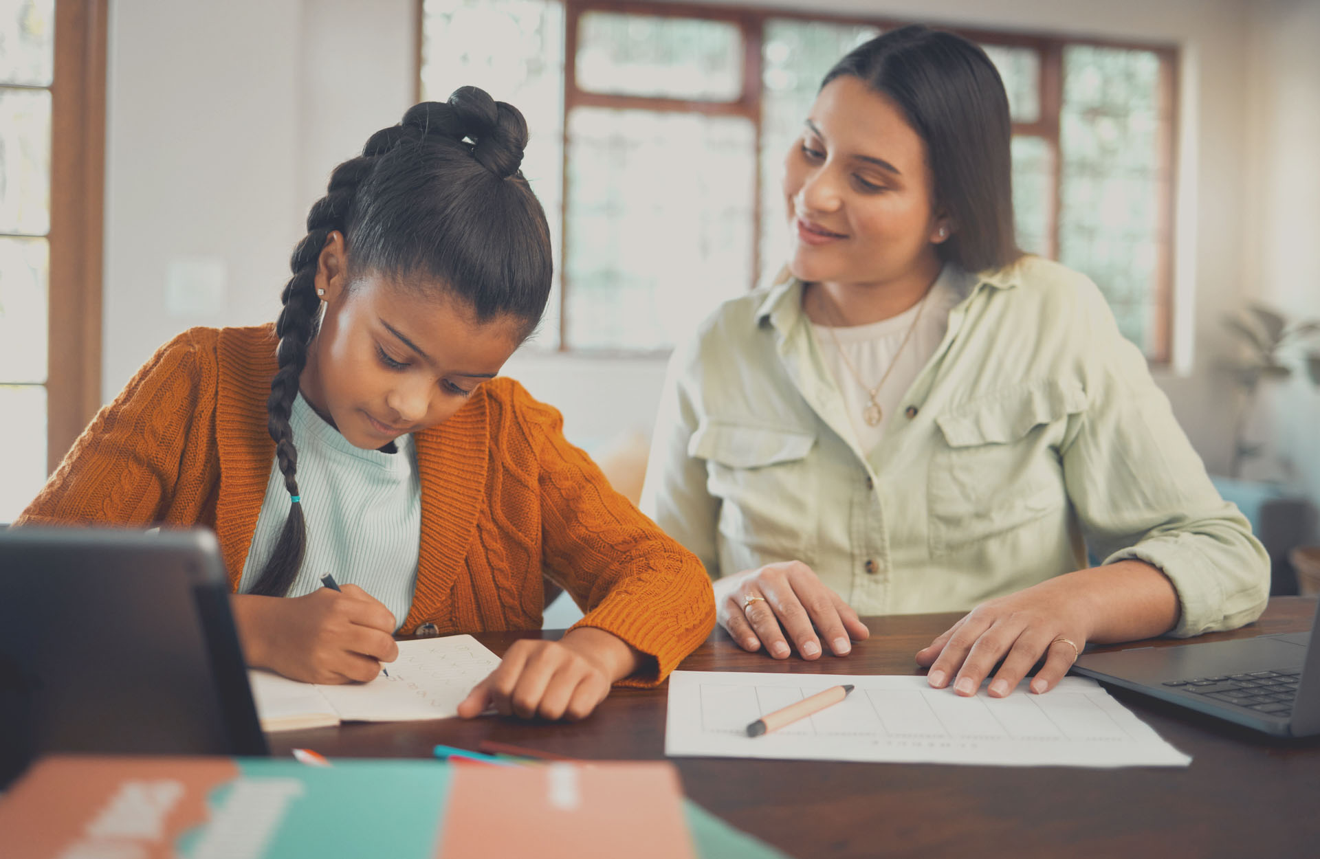 Student writing a letter with the teacher